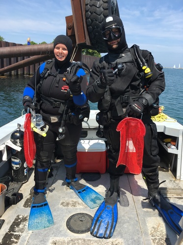 Two divers giving thumbs up. 