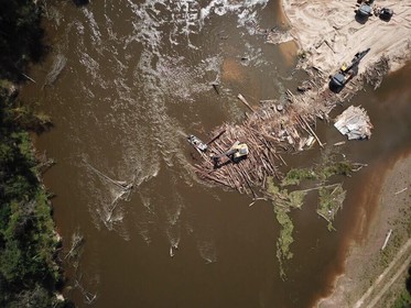 Construction equipment removes debris from the Pearl River. 