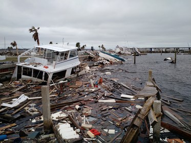 A half sunk boat is surrounded by floating wood debris generated from Hurricane Michael. The boat is located in Panama City Florida. 
