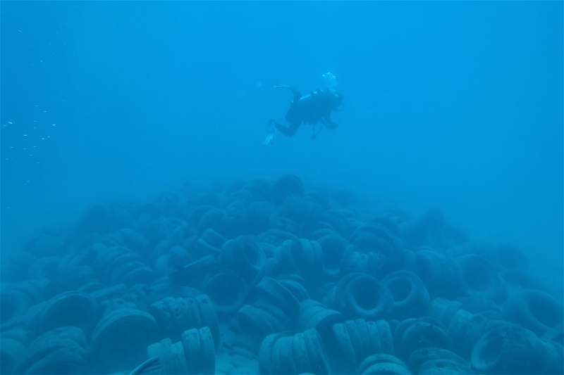 Tire reef with diver in the Cocos Lagoon