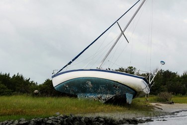 Derelict vessel on its side in a marsh