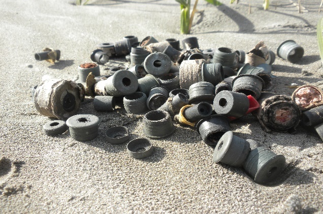 Firework debris, like these plastic plugs, can be left behind after Fourth of July celebrations (Photo: Ellen Anderson).