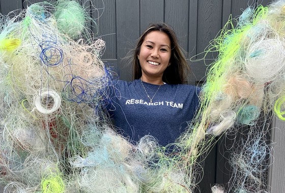 Volunteer holding collected fishing line from fishing line recycling bins on Maui. 