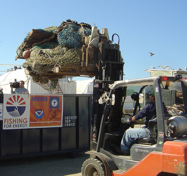 Derelict fishing gear being loaded into a dumpster