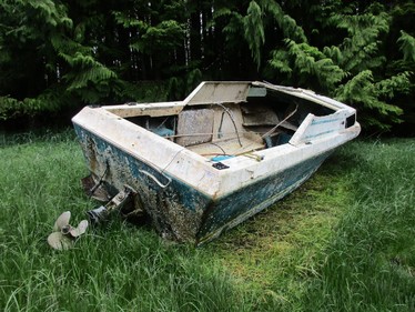 An abandoned vessel in a salt marsh.
