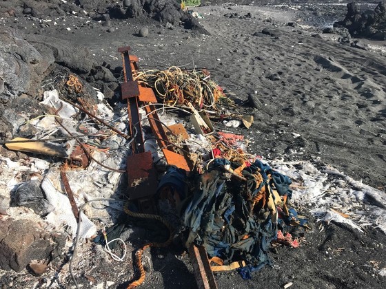 Marine debris on a beach from a grounded boat.