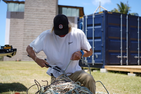 Parley AIR Station team member cutting a derelict fishing net.