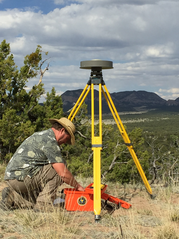Photo of a surveyor using GNSS survey equipment