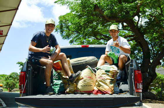 Two interns with a truck load of removed debris. 