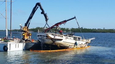 An abandoned and derelict vessel being removed from the water in the Florida Keys.