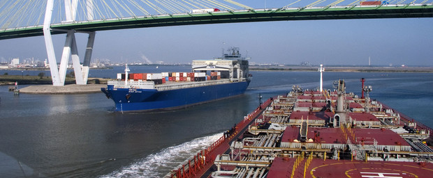 Ship navigating under the Fred Hartman Bridge