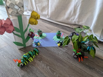 A scene made up of recycled-egg-carton bugs, frogs, turtles, and flowers. 