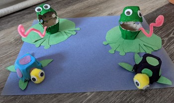 A pond made of blue construction paper with recycled-egg-carton frogs and turtles.