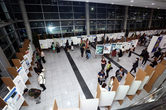 Event participants look at research posters at the Seventh International Marine Debris Conference. 