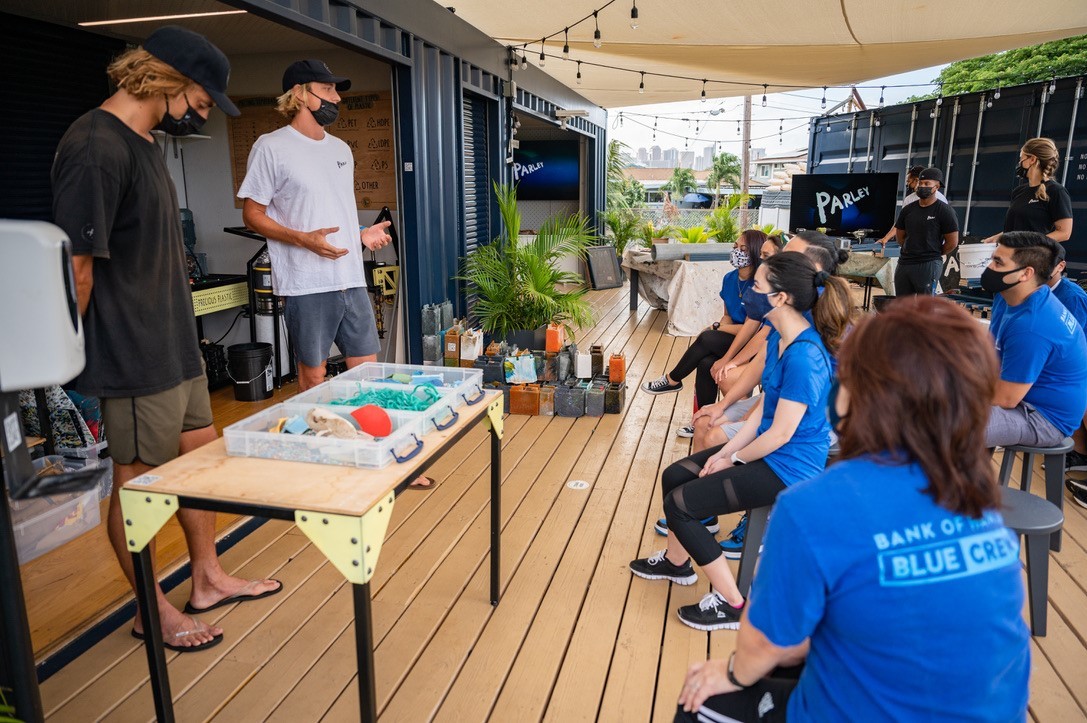 AIR Station coordinators explaining the marine debris upcycling initiative to a community group. 