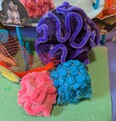 Purple, pink, and blue brain corals made from upcycled materials.