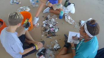 Students cleaning up and sorting marine debris.