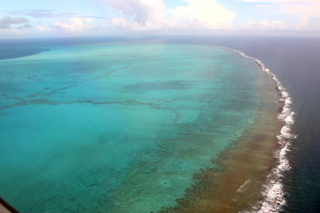 A aerial photograph of the barrier reef surrounding Midway Atoll.