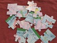 Cut out jigsaw pieces on a table.