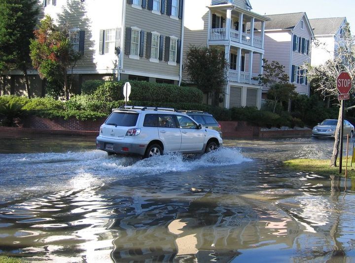 Car driving through a flooded street