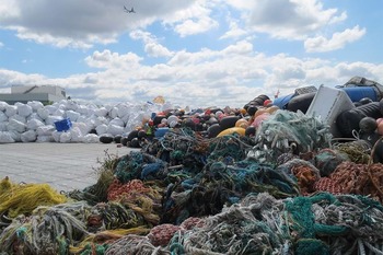 A mass of nets and other debris on a barge.