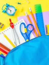 Blue Backpack with School supplies spilling out