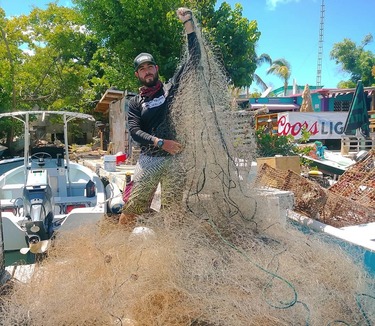 A person holds up a large net.