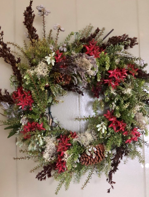 A festive wreath hanging on a door.