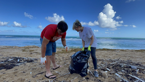 students collecting marine debris on beach