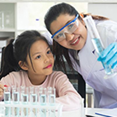 teacher and student looking at a test tube in a classroom lab