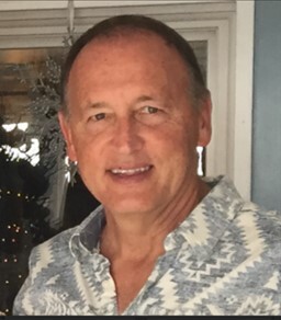 Headshot of an above middle aged man. 