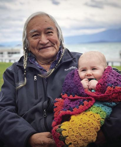 Old Native American woman holding a baby