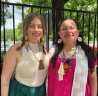 Amanda and a friend wearing street clothes enhanced by tribal adornments for a ceremony