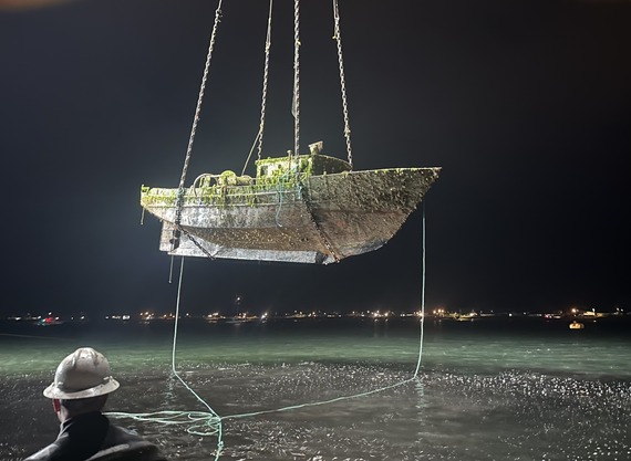 A derelict vessel is hosted from the water in WA.