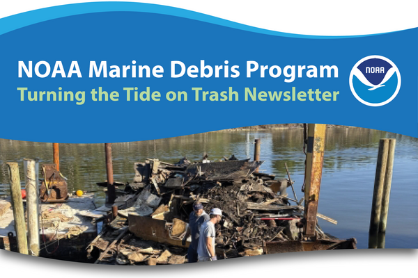 People loading pieces of debris onto a barge.