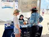 Woman talking to people at a booth