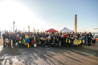 A large group of volunteers gathered after a community cleanup.