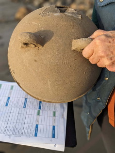 The top side of a buoy found in Netarts, Oregon. There is script indicating that this buoy originated in the western Pacific Ocean. 