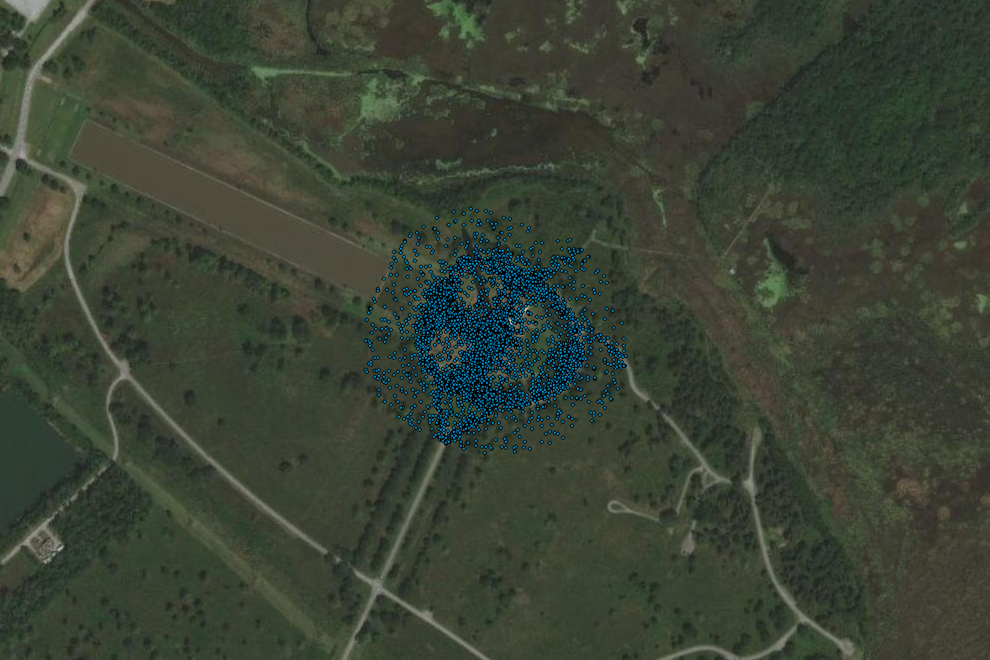 Overhead imagery of a site of interest. Blue dots overlaid on the image represent visits to the site. 