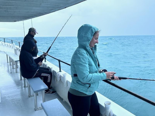 People fishing off a boat.