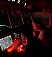 People looking at screens at night.