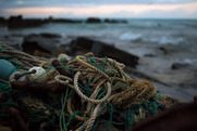 Derelict fishing nets litter the shoreline