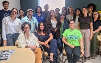 A large group of people smiling at the camera.