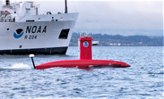 NOAA Ship Oscar Dyson and the bright orange DriX uncrewed surface vehicle
