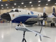An Altius aerial drone in front and a NOAA Hurricane Hunter aircraft in the background