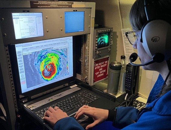Flight meteorologist at her station looking at a radar image of a hurricane