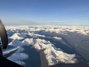 The view of snow covered mountains as seen from a NOAA aircraft