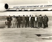 A group of airplane crew members standing in front of NOAA's Gulfstream IV jet