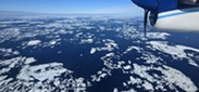 NOAA Twin Otter flies over sea ice during Bowhead Whale Surveys