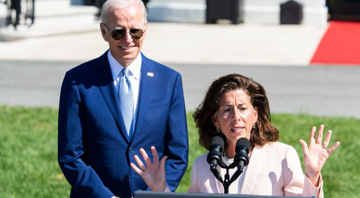 Secretary of Commerce Gina Raimondo speaks as President Joe Biden looks on, during The CHIPS and Science Act of 2022 bill signing